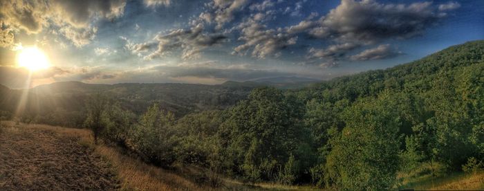 Scenic view of landscape against cloudy sky