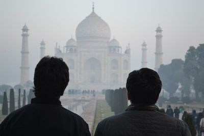 Rear view of people against sky