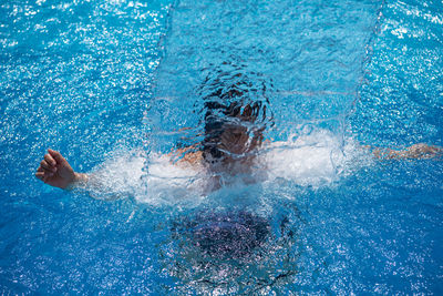 Man swimming in pool