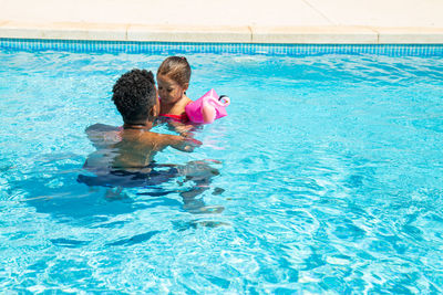 High angle view of boy swimming in pool