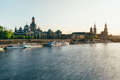 Boats in river with church in background