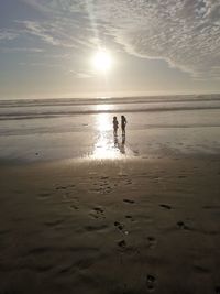 Scenic view of beach against sky during sunset