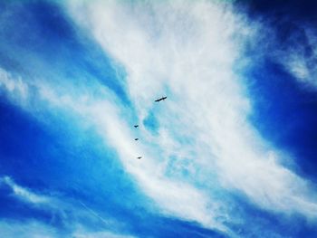 Low angle view of airplane flying against sky