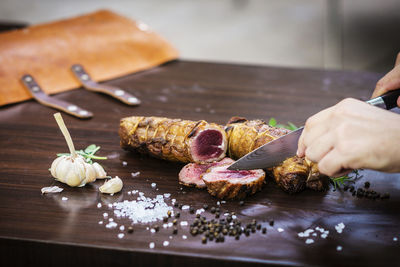 Close-up of person preparing food on cutting board