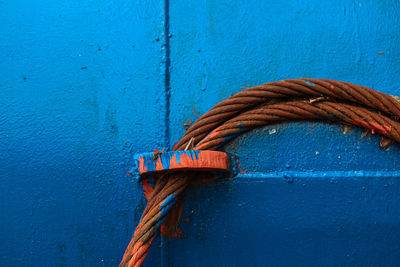 Close-up of rope tied on metal door