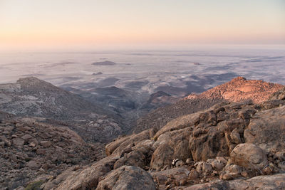 Scenic view of rocky mountains against sky during sunset