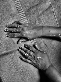 High angle view of woman hand on textile