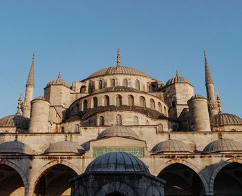 Low angle view of historical building against clear blue sky