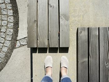 Low section of person standing on tiled floor