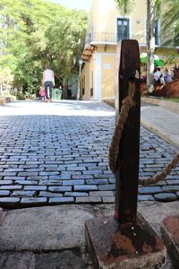 Footpath by street against building in city