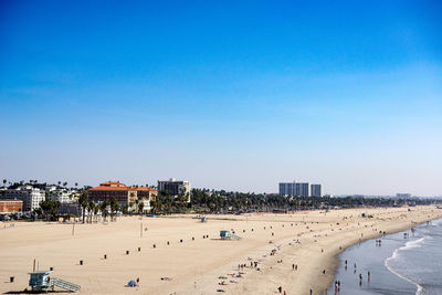 Panoramic view of beach against clear blue sky