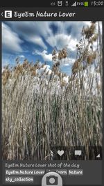 Information sign on field against sky
