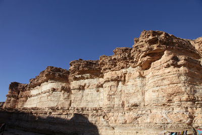 Rock formation against clear blue sky at sahara desert