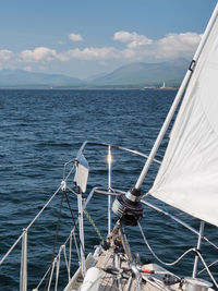 Sailboat sailing on sea against sky