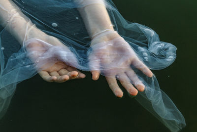 Low section of woman relaxing on water