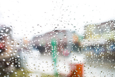 Full frame shot of wet glass window in rainy season