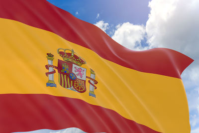 Low angle view of spanish flag against sky