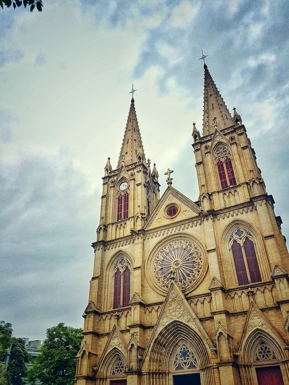 architecture, religion, building exterior, built structure, place of worship, church, low angle view, spirituality, sky, cathedral, tower, history, travel destinations, famous place, cloud - sky, clock tower, travel, tourism