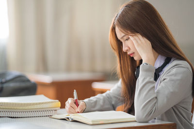 Young woman studying at classroom