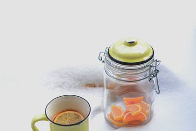 Close-up of drink in jar against white background