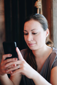 Woman using mobile phone in home