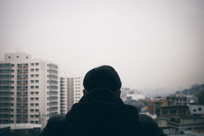 Rear view of cityscape against clear sky