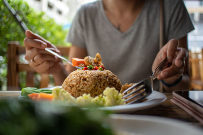 Woman is eating thai food in the restaurant