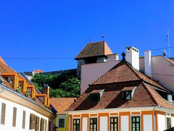 Low angle view of buildings against blue sky