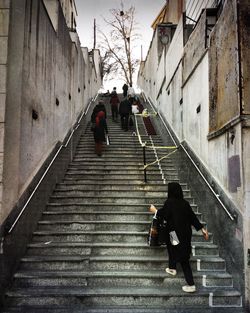 People walking on steps in city