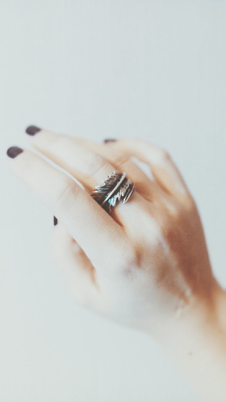 studio shot, white background, person, indoors, part of, close-up, cropped, human finger, lifestyles, copy space, human skin, holding, leisure activity, femininity, unrecognizable person, nail polish