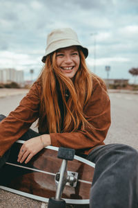 Portrait of a smiling young woman sitting outdoors