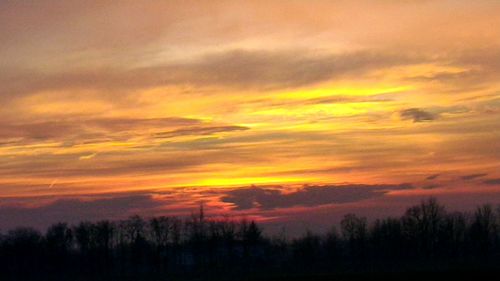 Silhouette landscape against sky during sunset