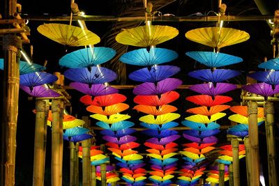 Low angle view of upside down colorful paper umbrellas hanging from ceiling