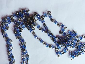 Close-up of purple chain on white table