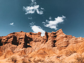 Low angle view of rock formations against sky