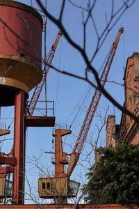 Low angle view of crane against clear sky