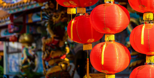 Illuminated lanterns hanging at market stall