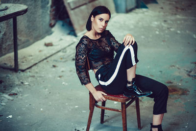 Portrait of young woman sitting on chair