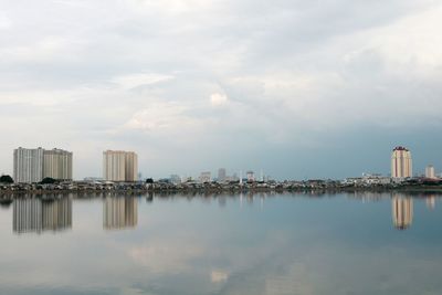 Panoramic view of sea and city against sky