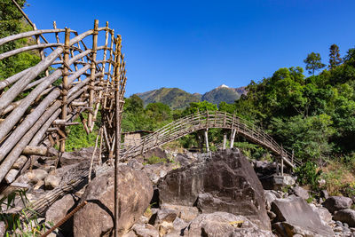 Traditional bamboo bridge for crossing river at forest at morning from low angle