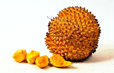 Close-up of orange fruit against white background