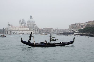 Scenic view of a gondola against venice cityscape