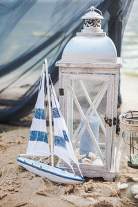 Close-up of deck chairs on table at beach