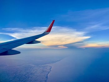 Aerial view of airplane flying in sky