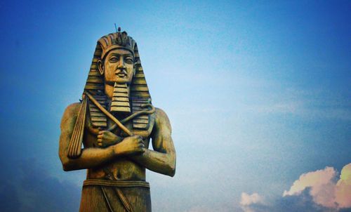 Low angle view of statue against blue sky