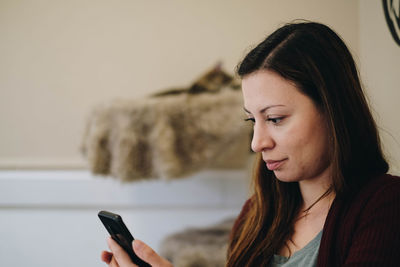 Portrait of young woman using mobile phone