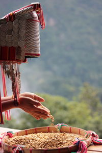 Midsection of person holding red basket