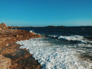 Scenic view of sea against clear blue sky