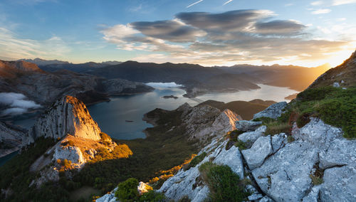 Scenic view of mountains and lake against sky during sunset