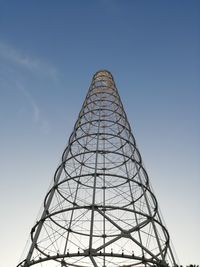 Low angle view of crane against clear blue sky